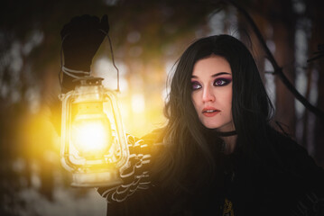 Beautiful young enchantress walking in the winter forest.