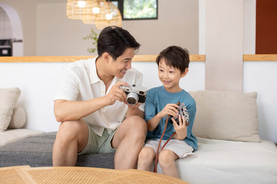 Happy father and son with cameras
