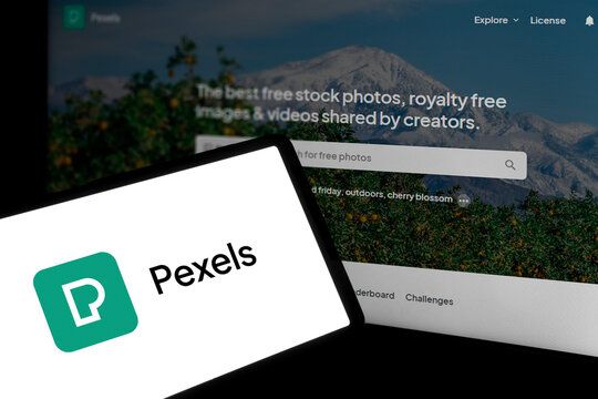 Dhaka, Bangladesh- 29 March 2024: Pexels logo is displayed on smartphone and pexels homepage on the background.