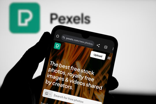 Dhaka, Bangladesh- 29 March 2024: Pexels.com homepage on smartphone and pexels logo on background.