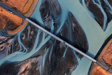 icelandic glacier river and bridge with red car view from above