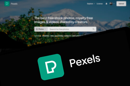 Dhaka, Bangladesh- 29 March 2024: Pexels logo is displayed on smartphone and pexels homepage on the background.