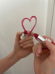 Hand holding red lipstick