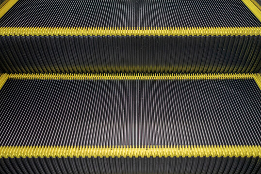 Escalator floor with copy space. Close up of the metal steps of a typical escalator. Staircase, Steps, Three Objects, Single Step, Motion