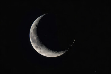 Detailed Crescent Moon in the night sky. Crescent Moon on black background with space for Ramadan theme.