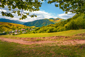 Dirty road to Kolochava village, Transcarpathian, Ukraine, Europe. Colorful summer view of Carpathian mountains. Beauty of countryside concept background..