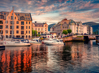 Spectacular summer sunset on Alesund port, town on the west coast of Norway, at the entrance to the...