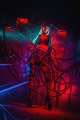 Fototapeta na wymiar Beautiful futuristic girl posing in the neon lights. Cyberpunk concept.