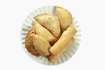 Plate with tasty empanadas on white background, top view