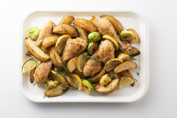 Chicken and potato dish on a white tray