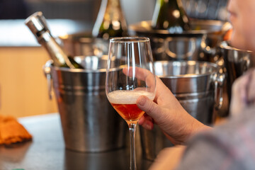 close up of a woman holding a glass of champagne in a restaurant