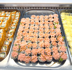 Sushi and rolls on a counter in a market