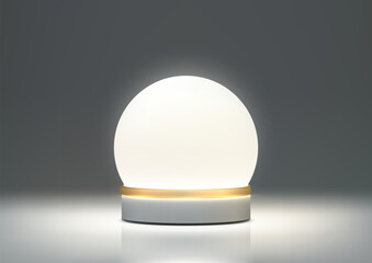 A sleek lamp with a white glass globe shade and a gold metal base sits on a white table