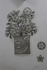 Beautiful picture frame on a white wall. Picture contains white and black colour flowers in Bahria town 07-09-2021