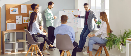 Group of business people chatting on a meeting sitting in circle in office. Company employees discussing work project. Coworkers listen to their colleague. Corporate business team concept. Banner.
