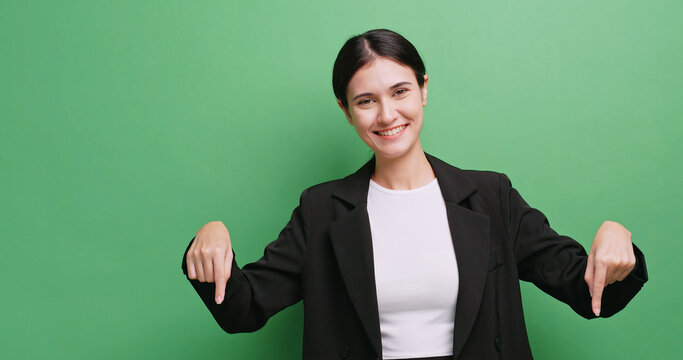 Happy young business woman showing something or copy space for product or sign text. Isolated on green background in studio. - Powered by Adobe