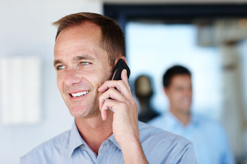 Phone call, smile and businessman talking, speaking and chat on mobile conversation, discussion or networking in workplace. Consultant, communication and connect with smartphone for business deal