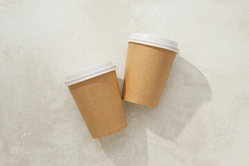Paper cups with lids on a light background