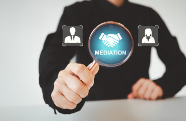 Mediation concept. Mediation between married couples, divorce and the role of the mediator. Businessman use magnifying glass focus to icon of woman and man and mediation on virtual screen.