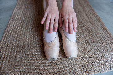 Close-Up of Ballet Dancers Feet in pointe on Textured Mat. Detailed view of ballet dancers feet in...