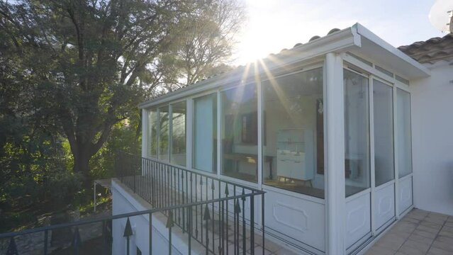 Slow orbiting shot of a small sunroom at a remote French villa 