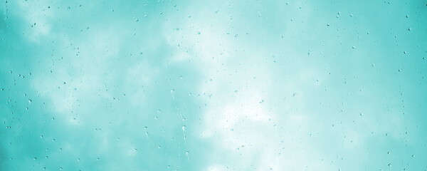 Raindrops, water dripping, rain on a glass pane, rainy weather with clouds - obrazy, fototapety, plakaty