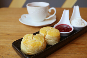 Closeup of Mouthwatering Scones with Blurry Teacup in the Backdrop