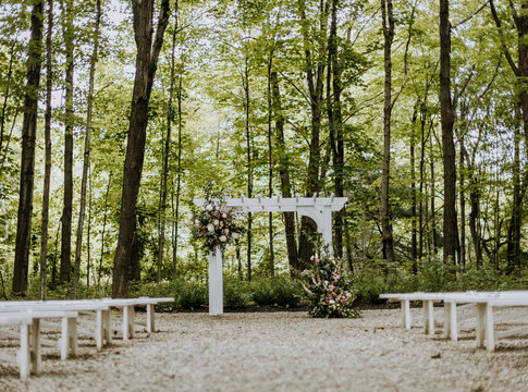 arbor and wedding flowers decorating ceremony area at wedding