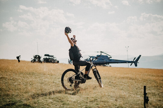 Happy young man after Heli drop adventure with Electric bicycle