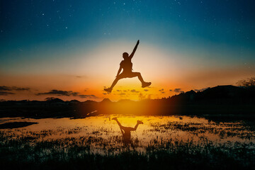 Silhouette of girl jumping in air with stars behind her