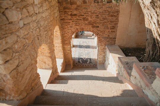 Shadows from afternoon light hits a set of stairs in ancient Africa.