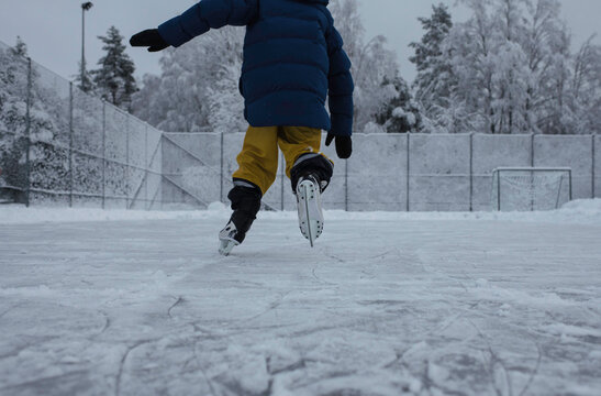 child ice skating in an outdoor ice rink in Stockholm