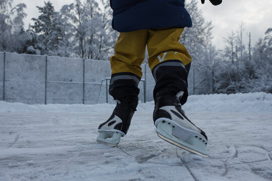 child ice skating outside in the snow in Sweden