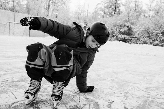 boy ice skating outside in the snow in Sweden