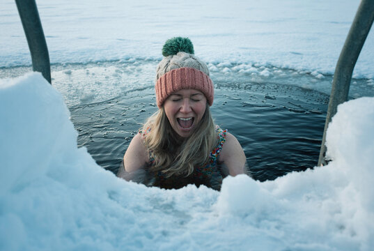 woman screaming whilst ice water cold water swimming in Scandinavia