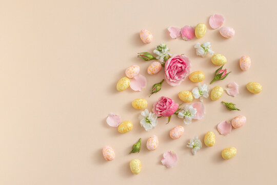 Easter Eggs and Flowers on Pastel Background