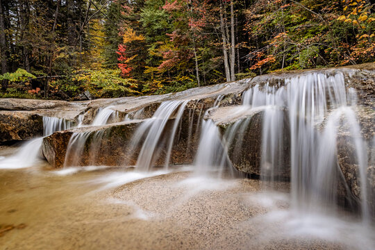 long exposure of waterfall flowing over granite rocks, New Hampshire