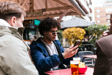 four multi ethnic friends drinking beers and talking
