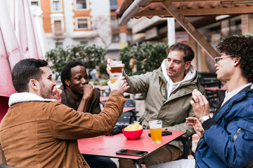 four multi ethnic friends drinking beers and talking