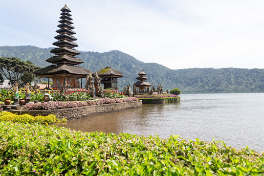 Iconic balinese Beratan temple next to lake during sunny day