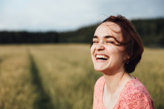 Portrait of a happy girl laughing in a field