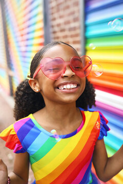 Young Girl with Big Smile in front of a mural in Washington, DC