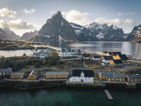 Aerial shot of stilt houses and bridge at island in winter