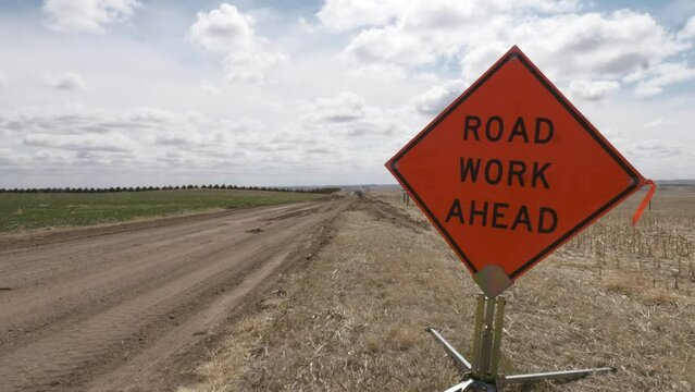 Road Work ahead sign on a windy day