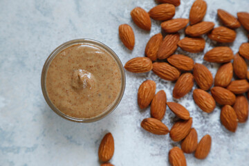 Homemade nuts butter in a glass jars with various nuts.