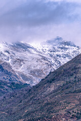 Horse peak with snow in Sierra Nevada with the Tello refuge on its slope, Granada.