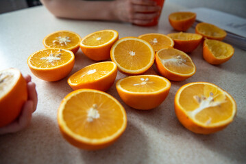 There are a lot of sliced juicy oranges on the table