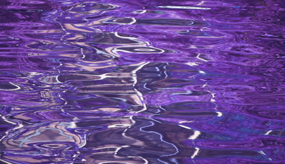 Amazing pop art surreal purple colored water surface in the sunlight for abstract background