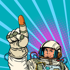Pop Art Retro The astronaut points with his index finger. Reaching forward to the stars Setting and completing tasks.