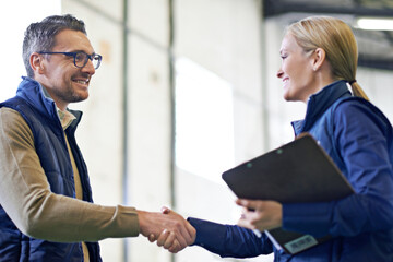 Business people, handshake and welcome for partnership, collaboration and agreement. Professional, clipboard and shaking hands for introduction, b2b onboarding or teamwork in shipping warehouse
